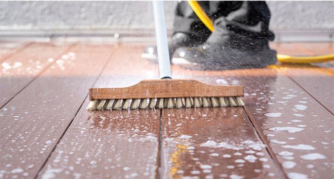 Brushing down decking with broom